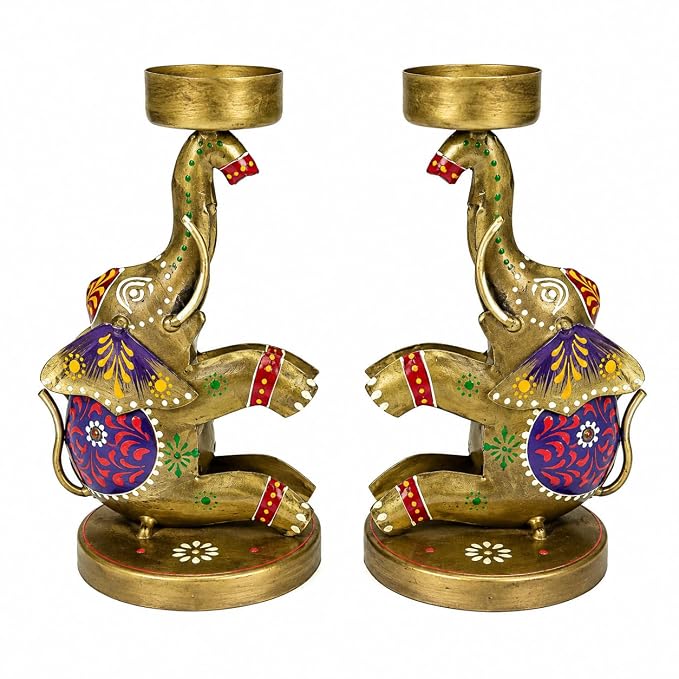 A pair of brass elephant candle holders decorated with colorful hand-painted patterns in purple, red, green, and gold, set against a plain white background.