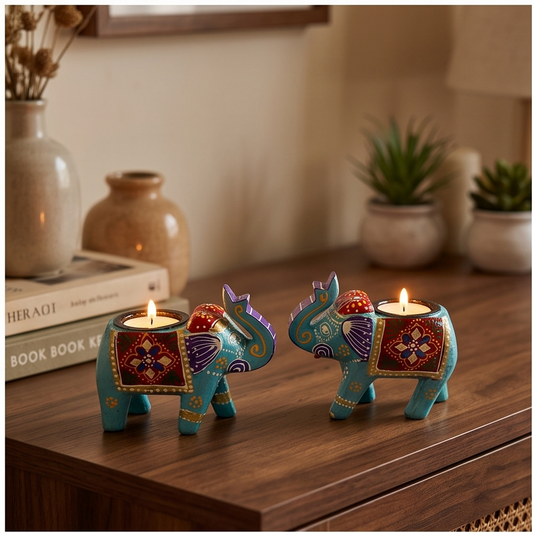A four-panel collage showing decorative elephant-shaped tealight candle holders in turquoise, red, purple, and gold. The holders are shown in different settings: on a wooden surface, on a shelf, and on a table, with lit candles inside.